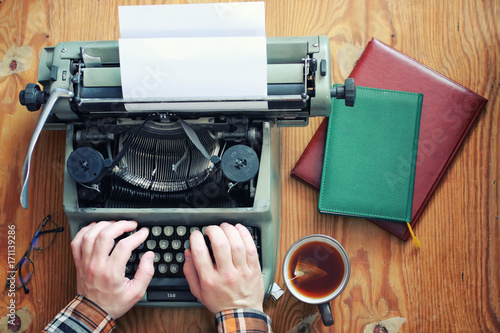 Wallpaper Mural typewriter retro hand on wooden table Torontodigital.ca