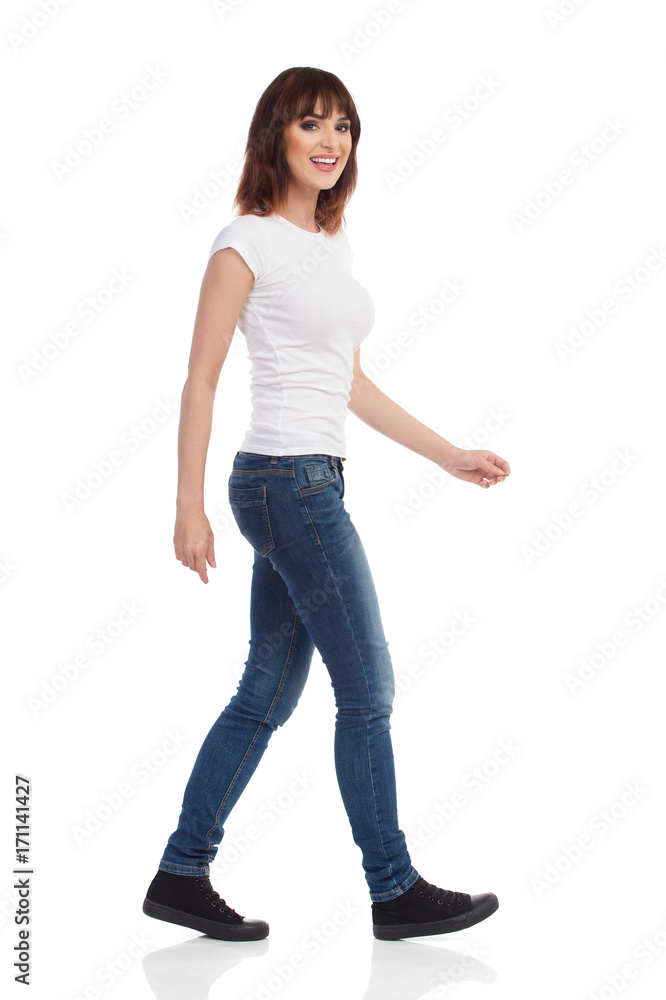 Smiling Young Woman Is Walking And Looking At Camera Smiling Young Woman Is Walking And Looking At Camera