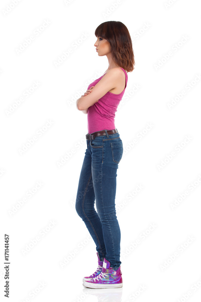 Skeptic Woman Is Standing With Arms Crossed. Side View Skeptic Woman Is Standing With Arms Crossed. Side View
