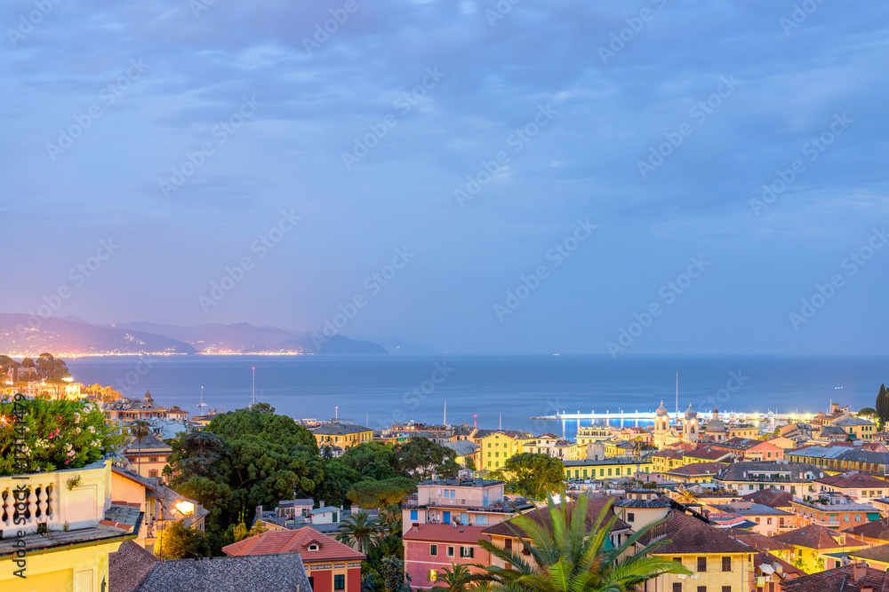 Beautiful night view to Santa Margherita Ligure city and sea in Italy. Flaring lights on background