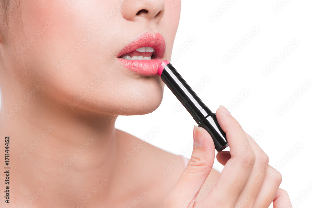 Beautiful young asian woman applying pink lipstick