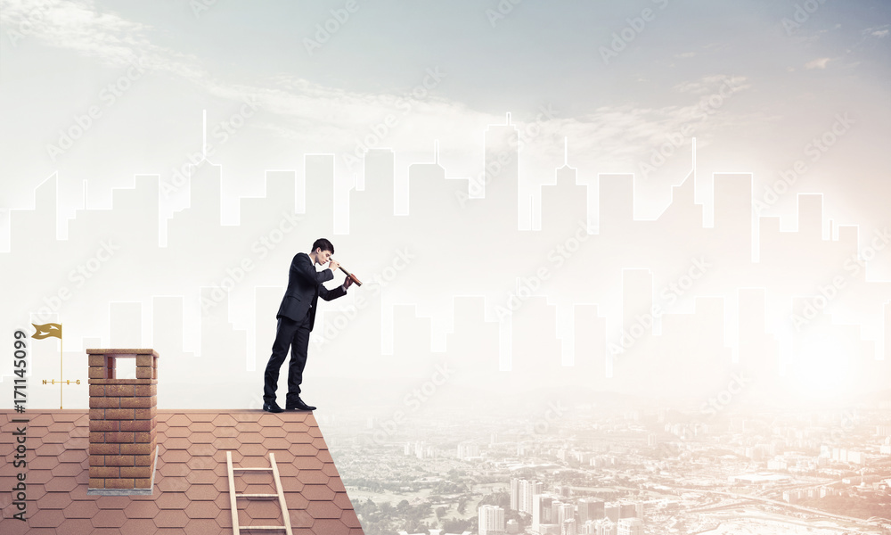 Engineer man standing on roof and looking in spyglass. Mixed med Engineer man standing on roof and looking in spyglass. Mixed med