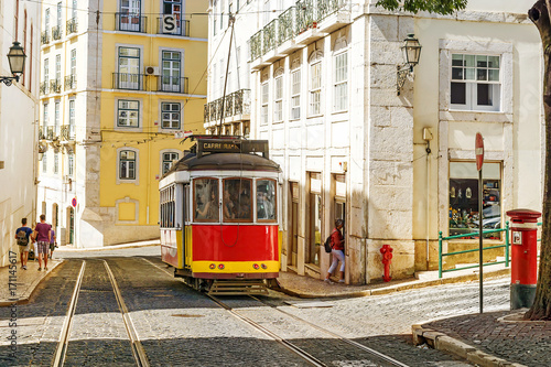 Red retro streetcar in the streets in Lisbon, Portugal