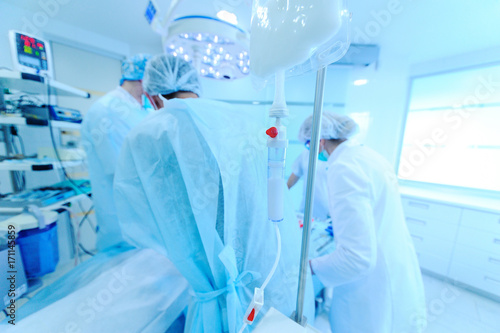 surgeons do surgery in a modern operating room or clinic