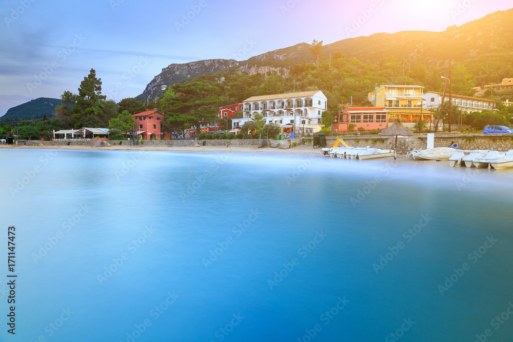 Long exposure landscape of Paleokastritsa famous sand beach in close bay on Corfu island at dusk, Ionian archipelago, Greece.