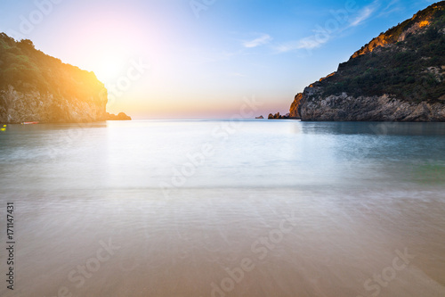 Long exposure landscape of Paleokastritsa famous sand beach in close bay on Corfu island at dusk, Ionian archipelago, Greece.