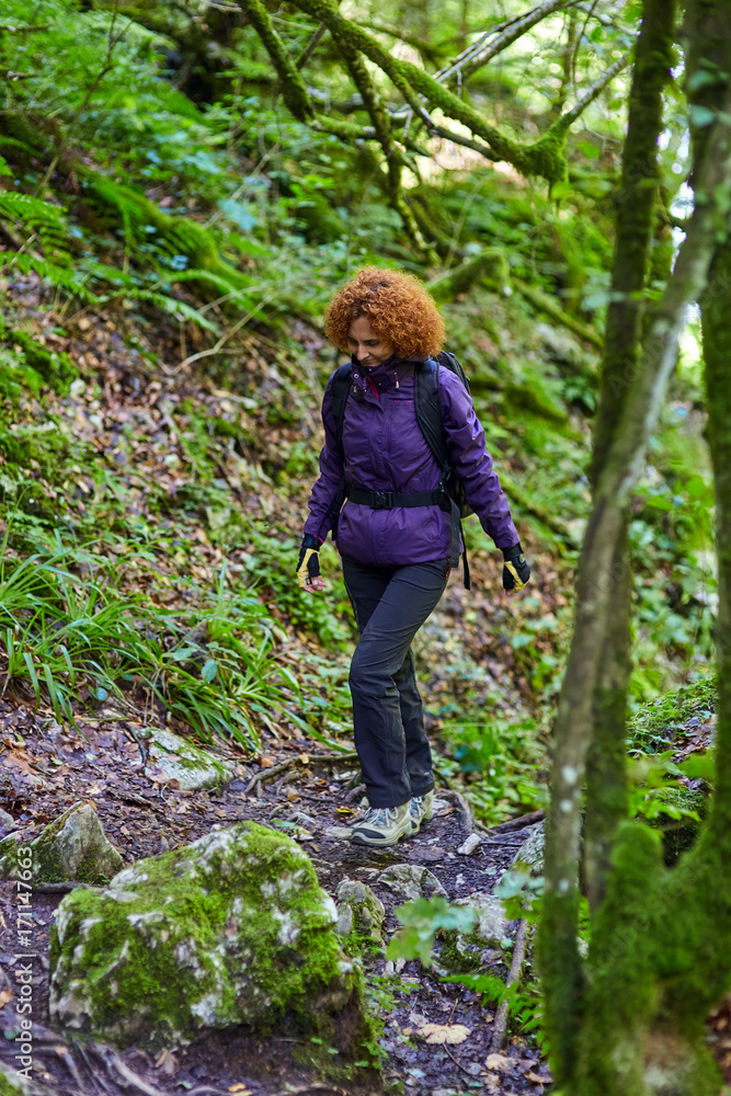 Woman with backpack on a trail