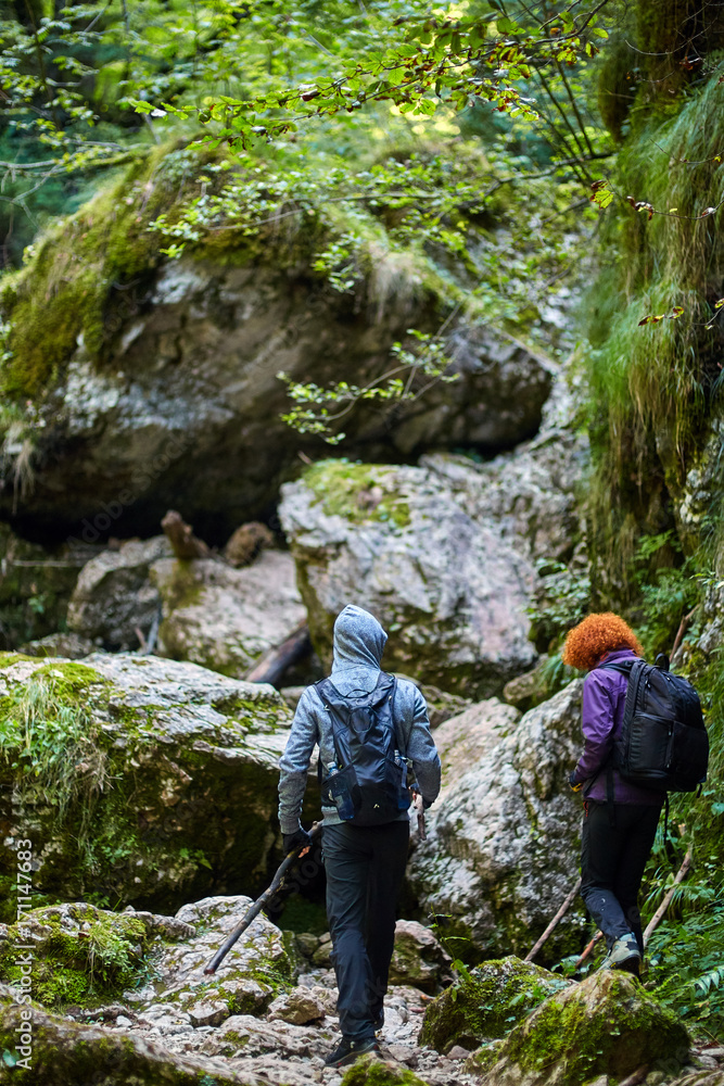 Hikers with backpacks in a canyon