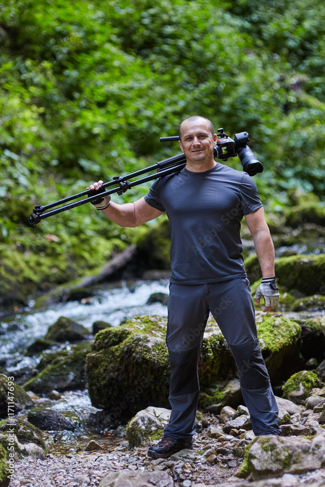 Professional nature photographer with camera on tripod