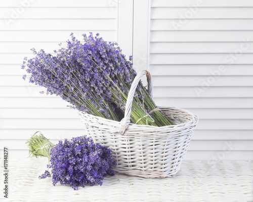 Basket with a lavender over white shutters.