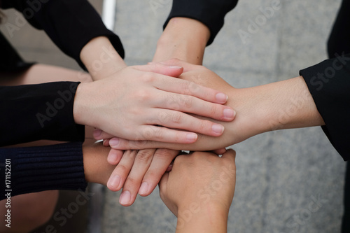 close up on group of employee hands corporate support together concept.