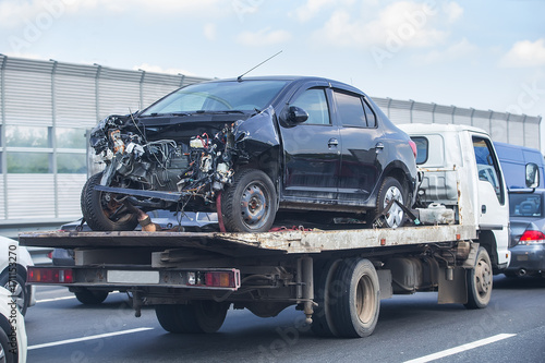 wrecker transports broken car