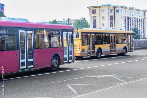 two buses go on city street