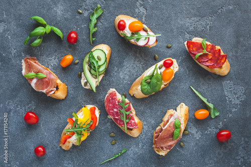 Traditional spanish tapas on dark background. Flat lay, top view