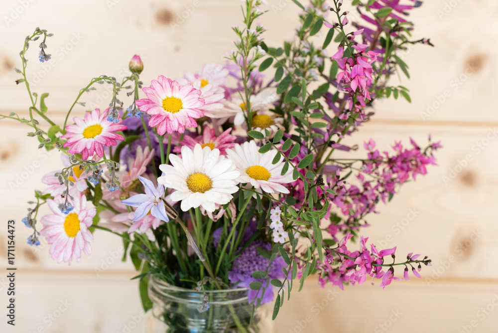 Close up of white daisies in purple and pink spring flower bouquet (selective focus)