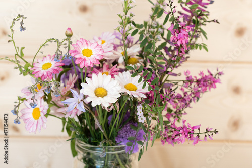 Close up of white daisies in purple and pink spring flower bouquet  selective focus 