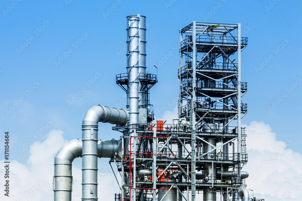 Refinery tower in petrochemical industrial plant with blue sky