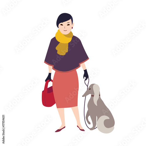 Elegant smiling woman dressed in stylish evening clothing standing and holdin...