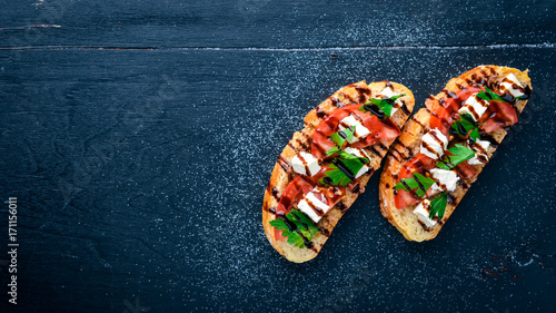 Tomato sandwich and feta cheese. On a wooden background. Top view. Free space for text.