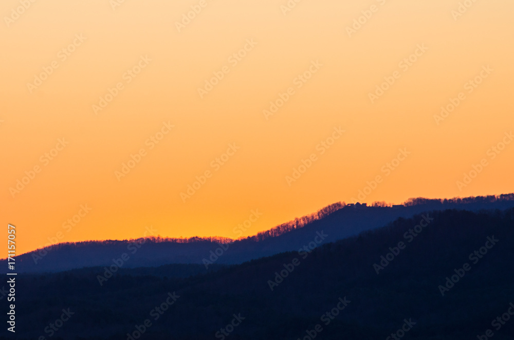 The pre-sunrise light of the sun begins to illuminate the hills near Heflin, Alabama, USA The pre-sunrise light of the sun begins to illuminate the hills near Heflin, Alabama, USA