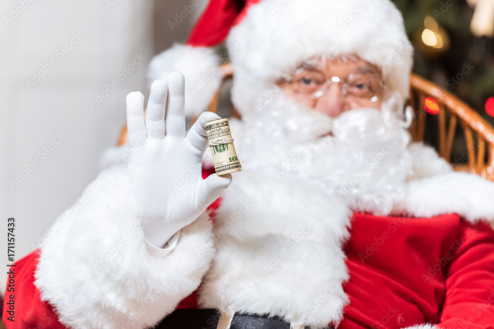 santa claus with roll of money