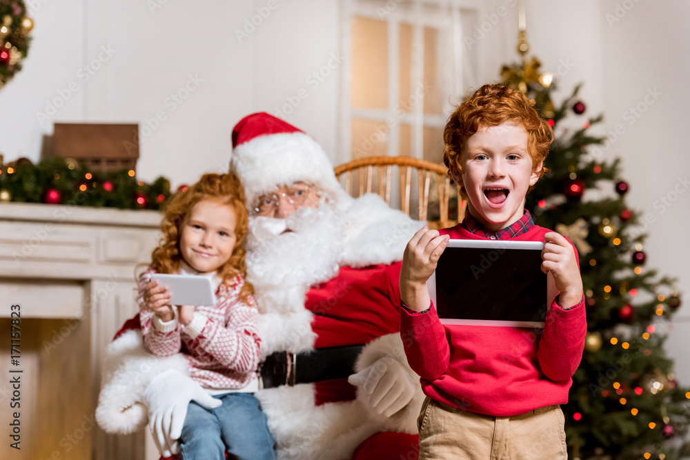 santa claus and children with digital devices santa claus and children with digital devices