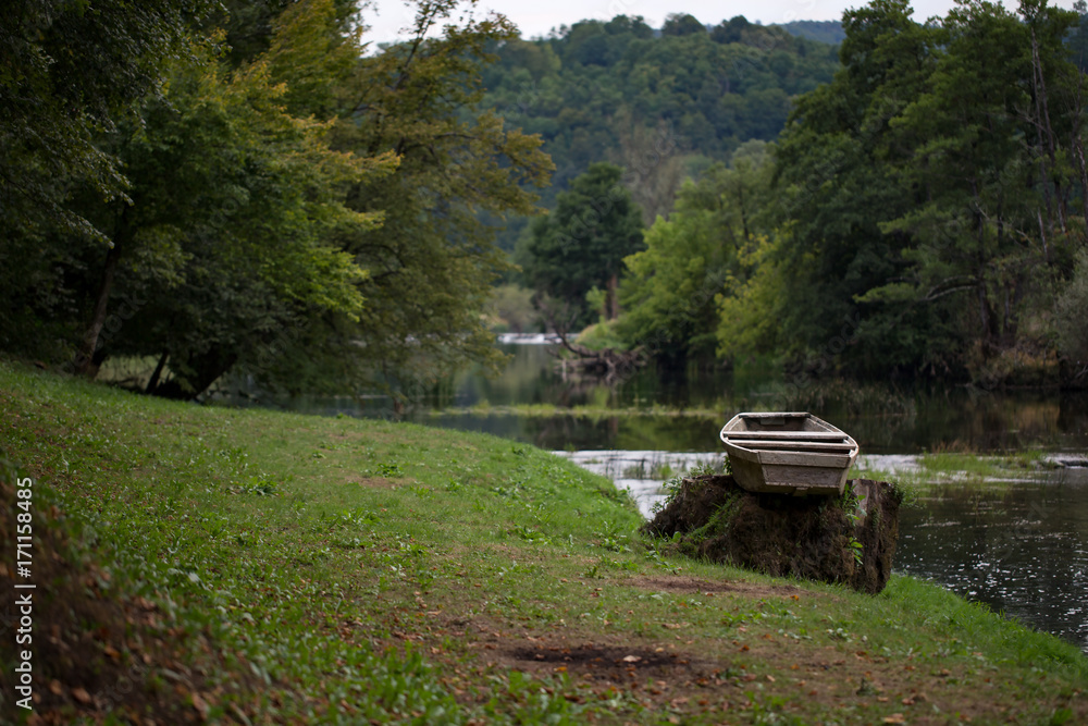 Lonely boat on the river bank Lonely boat on the river bank