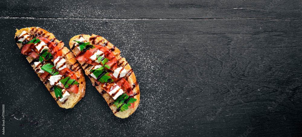 Tomato sandwich and feta cheese. On a wooden background. Top view. Free space for text.