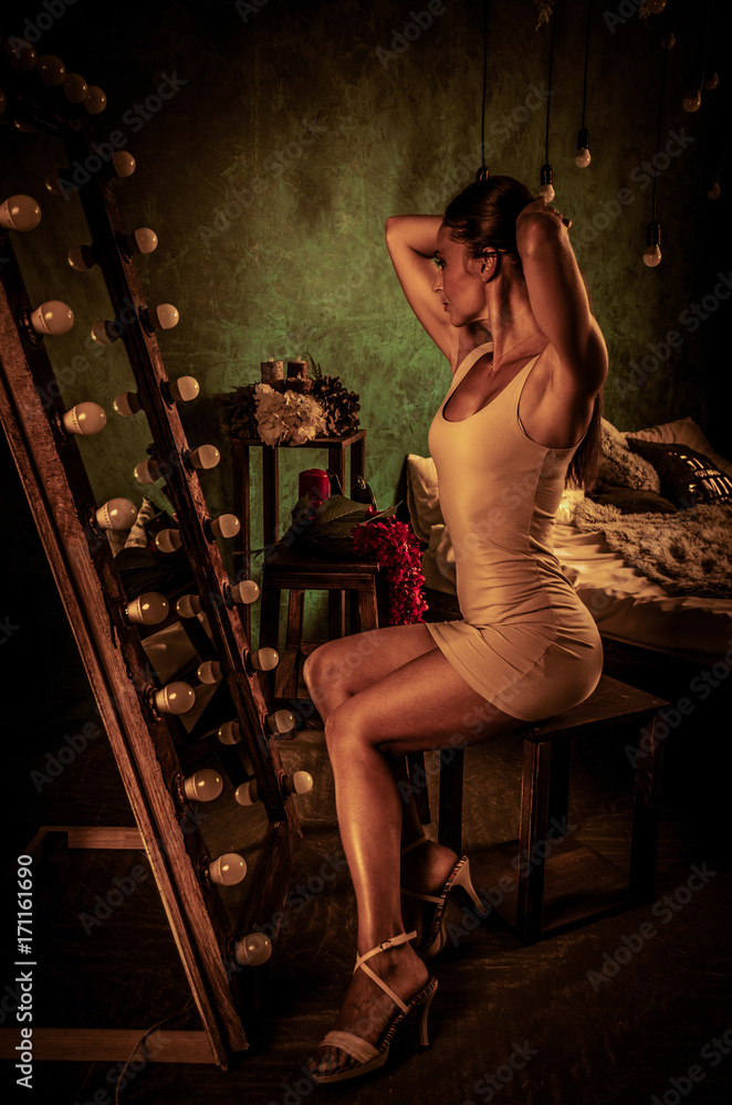 Adult fit woman in front of a mirror.