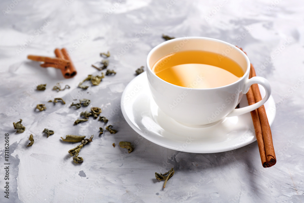 Cup of tasty cinnamon tea on table