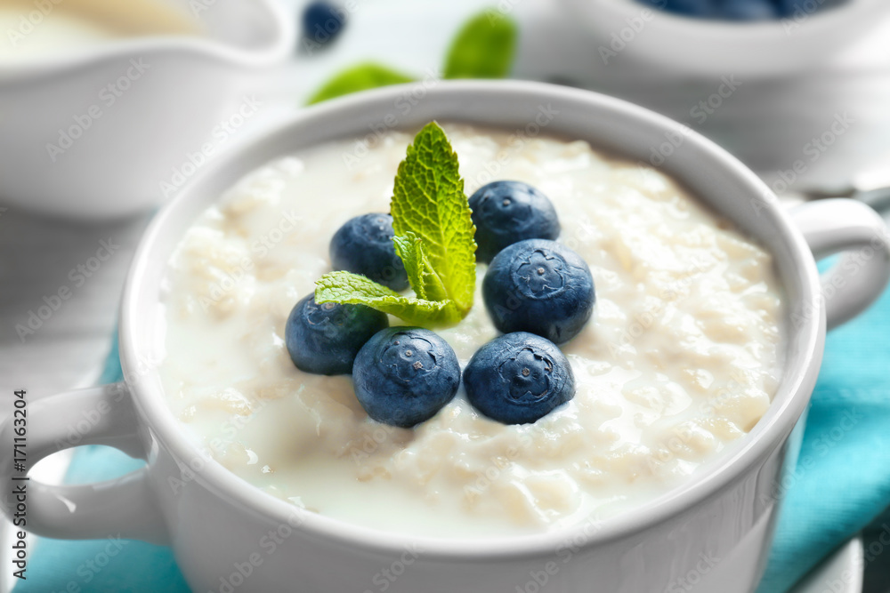 Creamy rice pudding with blueberries in bowl, closeup Creamy rice pudding with blueberries in bowl, closeup