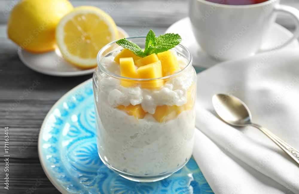 Creamy rice pudding with fruit in jar on table Creamy rice pudding with fruit in jar on table