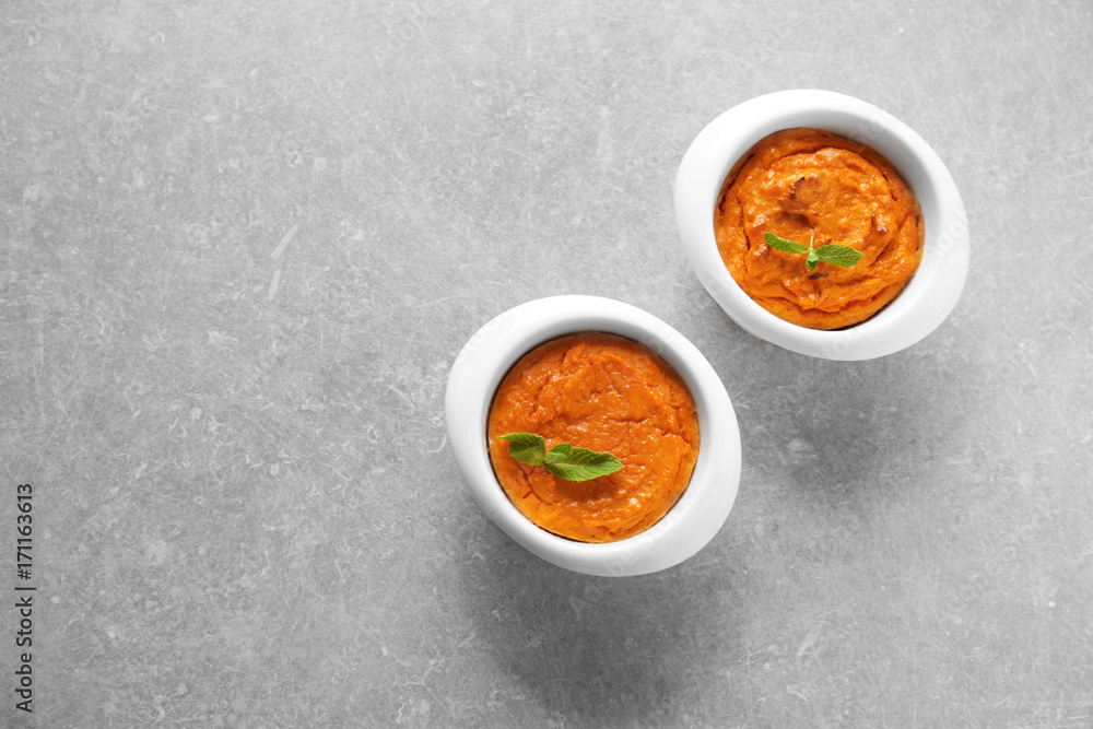 Ramekins with tasty carrot souffle on table Ramekins with tasty carrot souffle on table