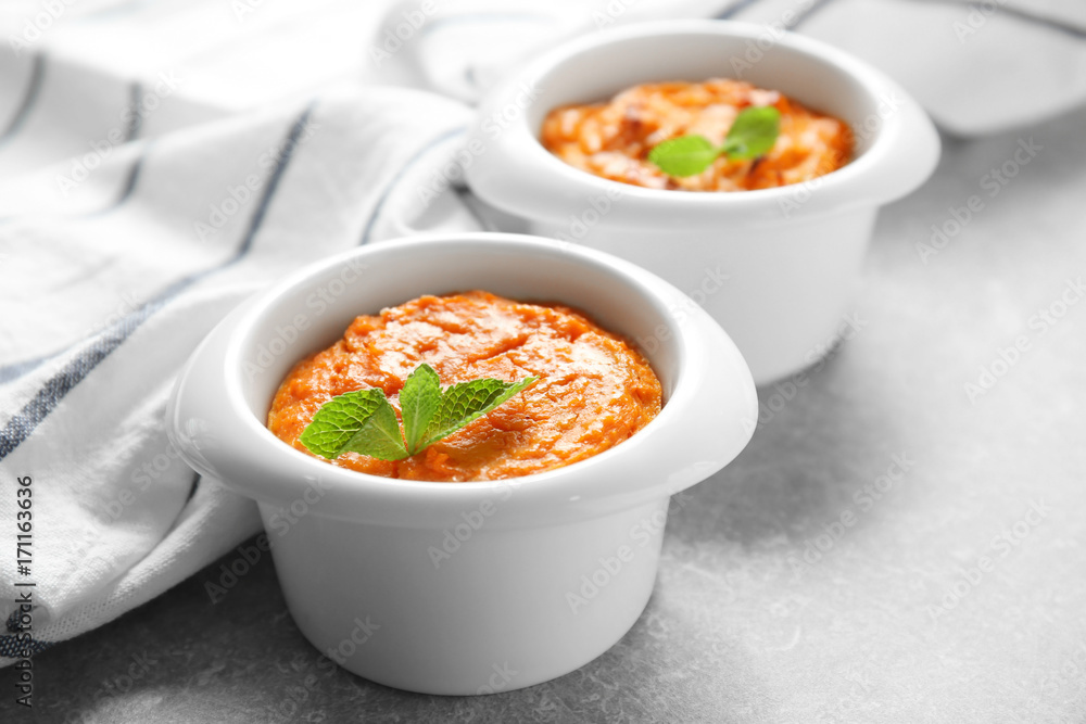Ramekins with tasty carrot souffle on table Ramekins with tasty carrot souffle on table