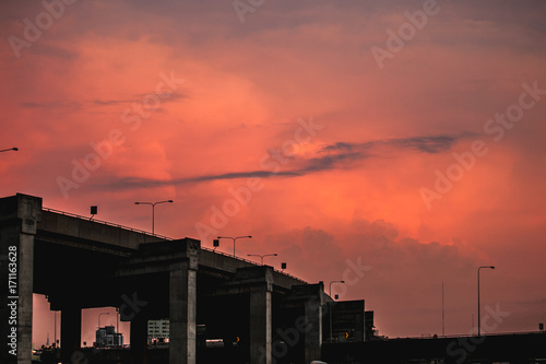 silhouette urban bridge after work with red twilight sky at the back