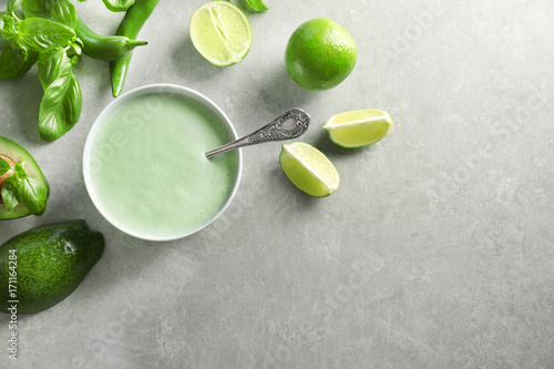 Creamy avocado lime sauce for fish taco in bowl on kitchen table