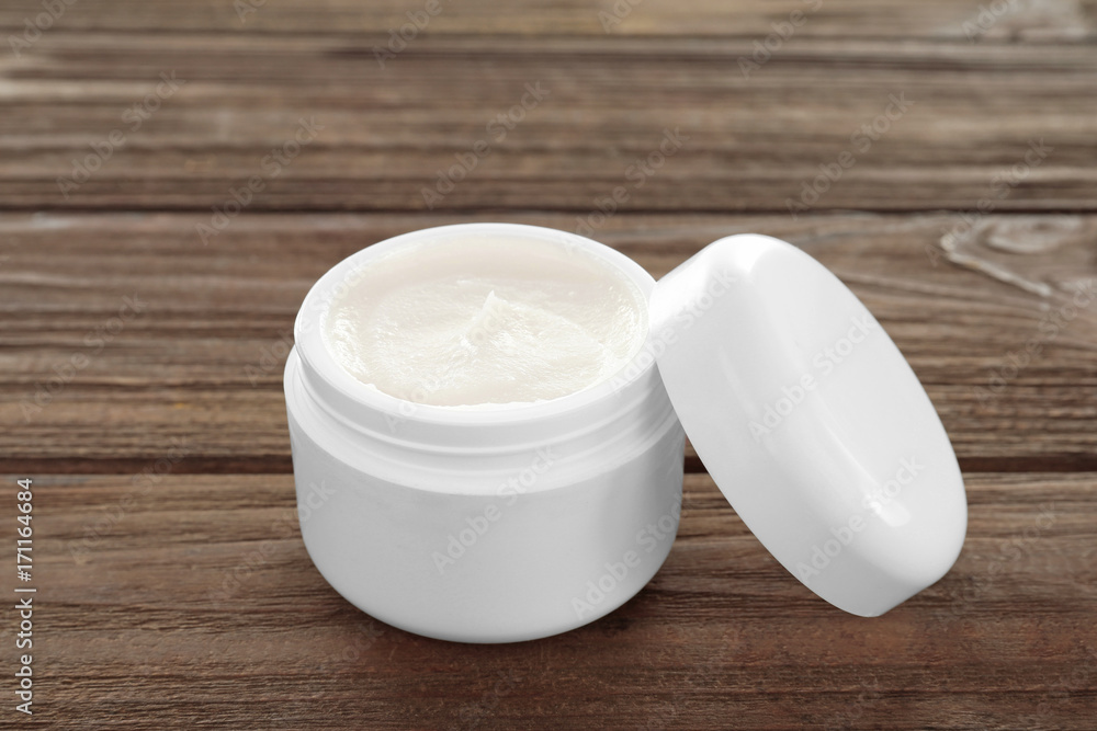 Coconut oil in jar on wooden background Coconut oil in jar on wooden background