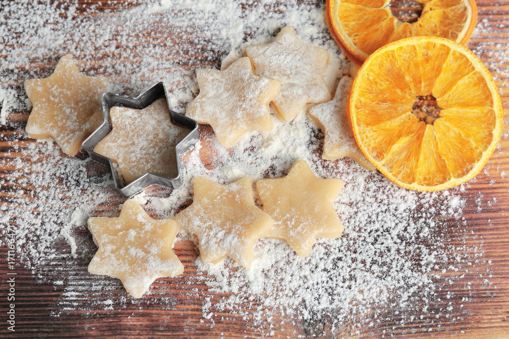 Composition of raw cookies and dried orange on wooden board Composition of raw cookies and dried orange on wooden board