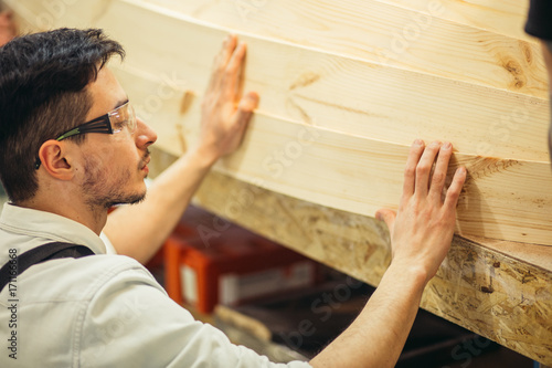 carpenter man in workshop glue wood work for construction photo