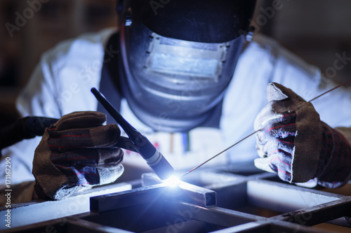 Bilde på lerret Industrial Worker at the factory welding closeup