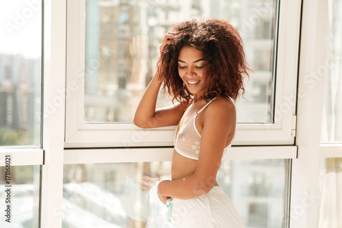 Smiling pretty afro american woman in lingerie posing