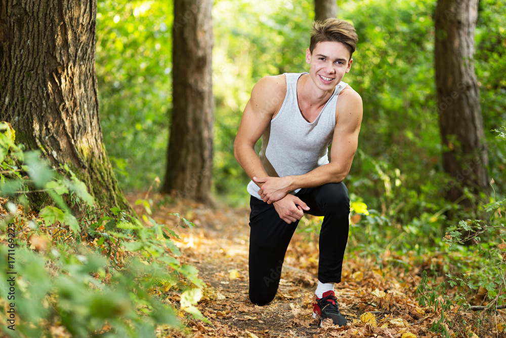 Young handsome blonde guy training outdoor and smiling Young handsome blonde guy training outdoor and smiling
