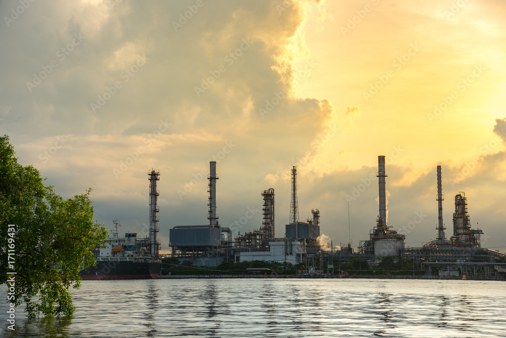 Oil Refinery Industry Plant in Bangkok, Thailand with cloudy sunrise background. Conventional energy concept.