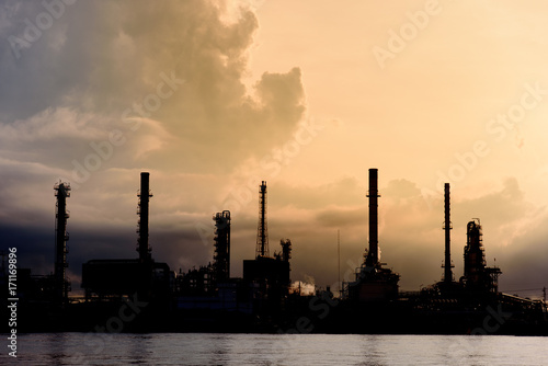Silhouette of Oil Refinery Industry Plant in Bangkok  Thailand with cloudy vivid sunrise background. Conventional energy concept.