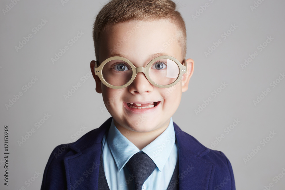 funny smiling child in glasses and siut