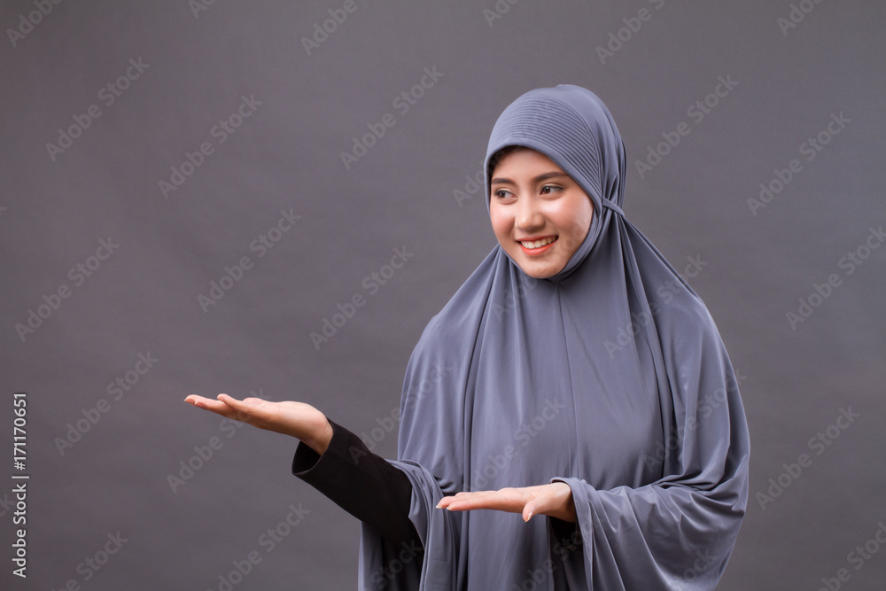 muslim woman pointing hand up to blank space muslim woman pointing hand up to blank space