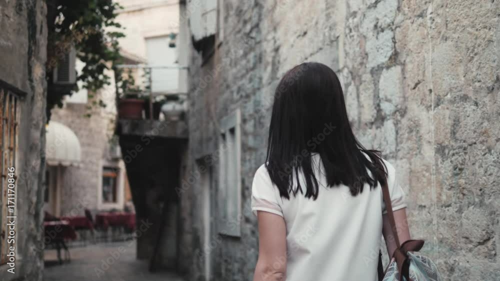 Outdoor Lifestyle Portrait of Young Woman Walking Down The Street At Old Town, Travel With Backpack, Stylish Casual Outfit, Evening Sunset Outdoor Lifestyle Portrait of Young Woman Walking Down The Street At Old Town, Travel With Backpack, Stylish Casual Outfit, Evening Sunset