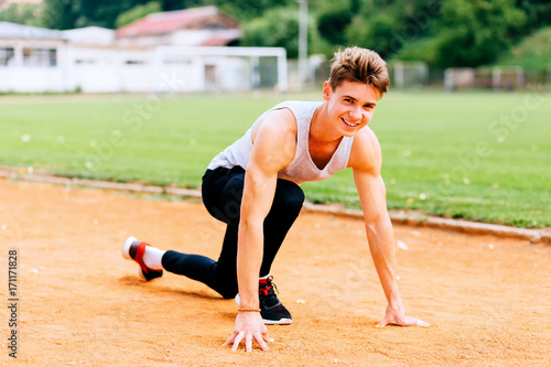 Young caucasian boy training outdoor. Sport and muscle concept