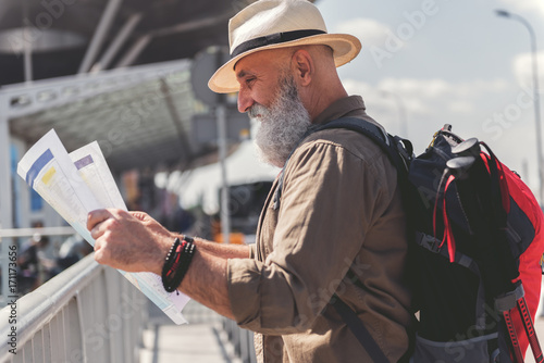 Curious bearded tourist choosing route