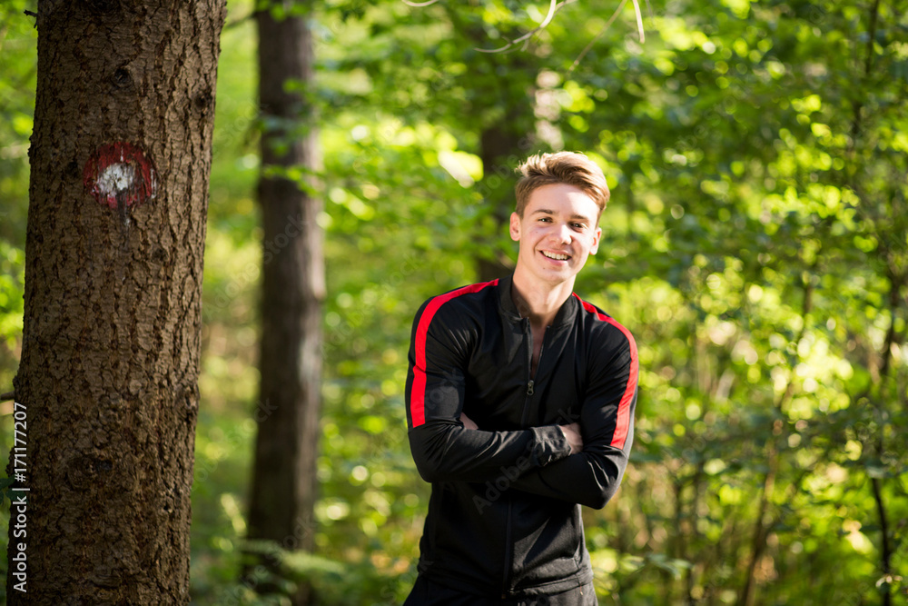 Young handsome blonde guy training outdoor and smiling Young handsome blonde guy training outdoor and smiling